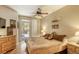 Comfortable bedroom with private balcony access, a ceiling fan, and warm decor at 3975 N Hualapai Way # 147, Las Vegas, NV 89129