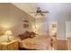 Cozy bedroom with hardwood floors, ceiling fan, and warm, inviting decor at 3975 N Hualapai Way # 147, Las Vegas, NV 89129