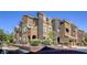 Multi-story building showing detailed architecture, with dual toned stucco and manicured landscaping with secure front fence at 3975 N Hualapai Way # 147, Las Vegas, NV 89129