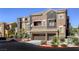 The home features a two-car garage and well-manicured landscaping and hardscape with desert vegetation at 3975 N Hualapai Way # 147, Las Vegas, NV 89129