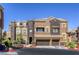 The property has a two-car garage, desert landscaping, and dual-tone stucco details at 3975 N Hualapai Way # 147, Las Vegas, NV 89129