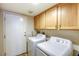 Functional laundry room with washer, dryer, and ample cabinet storage space at 3975 N Hualapai Way # 147, Las Vegas, NV 89129