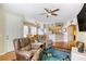 Comfortable living room with wood floors and modern decor leading to a sunlit dining area and kitchen at 3975 N Hualapai Way # 147, Las Vegas, NV 89129