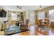 Spacious living area with hardwood floors, ceiling fans, large windows and comfortable seating for relaxing at 3975 N Hualapai Way # 147, Las Vegas, NV 89129