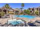Community pool and hot tub area with lounge seating and mature trees at 3975 N Hualapai Way # 147, Las Vegas, NV 89129