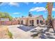 Home exterior featuring a spacious concrete patio, mature trees, and block wall, ideal for outdoor living at 4498 Via San Rafael, Las Vegas, NV 89103