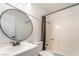 Modern bathroom features a sleek vanity with black faucet and a shower-tub combination at 4498 Via San Rafael, Las Vegas, NV 89103