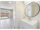 Charming bathroom with beadboard walls, new vanity, faucet, mirror, and vinyl plank floors, plus backyard view at 4498 Via San Rafael, Las Vegas, NV 89103