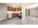 Modern kitchen featuring stainless steel appliances, wood cabinets, light walls, and new wood-style flooring at 4498 Via San Rafael, Las Vegas, NV 89103