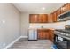 Galley kitchen features wood cabinets, butcher block counters, stainless steel appliances and vinyl plank flooring at 4498 Via San Rafael, Las Vegas, NV 89103