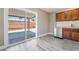 Kitchen area with stainless steel dishwasher, wood cabinets, and a sliding glass door to the backyard at 4498 Via San Rafael, Las Vegas, NV 89103