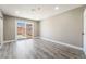 Spacious living room featuring sliding glass door to backyard and modern flooring at 4498 Via San Rafael, Las Vegas, NV 89103