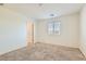 Bright bedroom with neutral carpet, window, closet, and light-colored walls offers comfortable living space at 4539 Cotton Quail Ave, Las Vegas, NV 89115