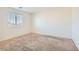 This bedroom is painted with neutral tones and is equipped with plush carpeting and a window at 4539 Cotton Quail Ave, Las Vegas, NV 89115