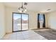 Bright dining area features tile flooring, modern lighting fixture and sliding glass doors to backyard at 4539 Cotton Quail Ave, Las Vegas, NV 89115