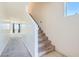 Hallway leading to carpeted stairs, and two bedroom entrances, all naturally lit by a window at 4539 Cotton Quail Ave, Las Vegas, NV 89115