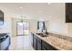 Kitchen and dining area with granite countertops, a double sink, and sliding glass doors to the yard at 4539 Cotton Quail Ave, Las Vegas, NV 89115