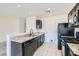 Well-lit kitchen area showcasing dark cabinetry, granite countertops, and a breakfast bar at 4539 Cotton Quail Ave, Las Vegas, NV 89115