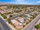 High-angle aerial showcasing home, backyard with covered patio, and surrounding neighborhood at 4818 Al Carrison St, Las Vegas, NV 89149