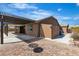 Wide view of landscaped backyard featuring a pergola, brick patio, and low maintenance turf at 4818 Al Carrison St, Las Vegas, NV 89149