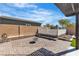 The backyard has a built-in fire pit, decorative brickwork, and low maintenance turf at 4818 Al Carrison St, Las Vegas, NV 89149