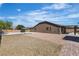 Spacious backyard with gravel, patio, block wall, and a covered patio area for outdoor entertaining at 4818 Al Carrison St, Las Vegas, NV 89149