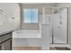 Bright bathroom showcases a soaking tub and glass enclosed shower with modern finishes at 4818 Al Carrison St, Las Vegas, NV 89149