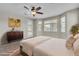 Staged bedroom with natural light, dresser, and neutral bedding at 4818 Al Carrison St, Las Vegas, NV 89149