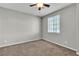 Neutral bedroom with a ceiling fan, carpet, and a window at 4818 Al Carrison St, Las Vegas, NV 89149