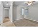 Inviting bedroom with soft carpet, a ceiling fan, and sunlit windows at 4818 Al Carrison St, Las Vegas, NV 89149