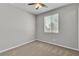 Serene bedroom with neutral paint, soft carpet, ceiling fan and sunlit windows at 4818 Al Carrison St, Las Vegas, NV 89149