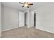 Bright bedroom with ceiling fan, doors, and carpeted floors at 4818 Al Carrison St, Las Vegas, NV 89149