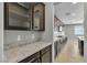 Butler pantry with stylish cabinets, granite counters and tile flooring at 4818 Al Carrison St, Las Vegas, NV 89149