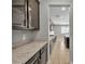 Butler pantry with stylish cabinets, granite counters and tile flooring at 4818 Al Carrison St, Las Vegas, NV 89149