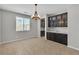 Bright dining area with dark cabinetry, granite countertop, view of exterior landscape, and modern chandelier at 4818 Al Carrison St, Las Vegas, NV 89149