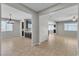 Open concept dining area with elegant chandelier, adjacent to the kitchen and living areas at 4818 Al Carrison St, Las Vegas, NV 89149