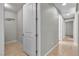 Hallway leads to laundry room, accentuated by neutral paint and tile floors at 4818 Al Carrison St, Las Vegas, NV 89149