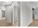 Neutral hallway leads to the bathroom and other rooms, accented with tile floors at 4818 Al Carrison St, Las Vegas, NV 89149