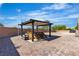 Landscaped backyard features a covered hot tub, providing the ultimate relaxation and privacy at 4818 Al Carrison St, Las Vegas, NV 89149