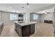 Open kitchen featuring a large island with a sink and granite counters at 4818 Al Carrison St, Las Vegas, NV 89149