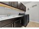 Laundry room includes modern washer and dryer, plus ample counter and cabinet space at 4818 Al Carrison St, Las Vegas, NV 89149