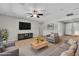 Open living room with large screen television, neutral paint, recessed lighting, and direct front door access at 4818 Al Carrison St, Las Vegas, NV 89149