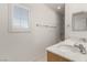 Bathroom featuring double sinks and a window with plantation shutters at 519 Brinkburn Point Ave, Las Vegas, NV 89178