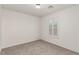This bedroom features carpet and a window with plantation shutters at 519 Brinkburn Point Ave, Las Vegas, NV 89178