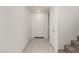 Well-lit entryway features tile flooring, white walls, a coat closet, and a carpeted staircase at 519 Brinkburn Point Ave, Las Vegas, NV 89178