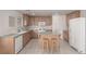 Kitchen with island and stool seating featuring tile floors and white appliances at 519 Brinkburn Point Ave, Las Vegas, NV 89178