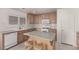 Kitchen featuring tile floors, ample counter space, and a central island with barstool seating at 519 Brinkburn Point Ave, Las Vegas, NV 89178