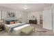 Bright main bedroom staged with large bed, bench, and modern decor accents at 519 Brinkburn Point Ave, Las Vegas, NV 89178