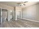 Neutral bedroom with hard surface floors, ceiling fan and doorways to the bathroom and closet at 5251 Graystone, Pahrump, NV 89061