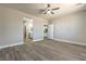 Spacious bedroom with wood-look floors, a ceiling fan, and doors to the bathroom and walk-in closet at 5251 Graystone, Pahrump, NV 89061